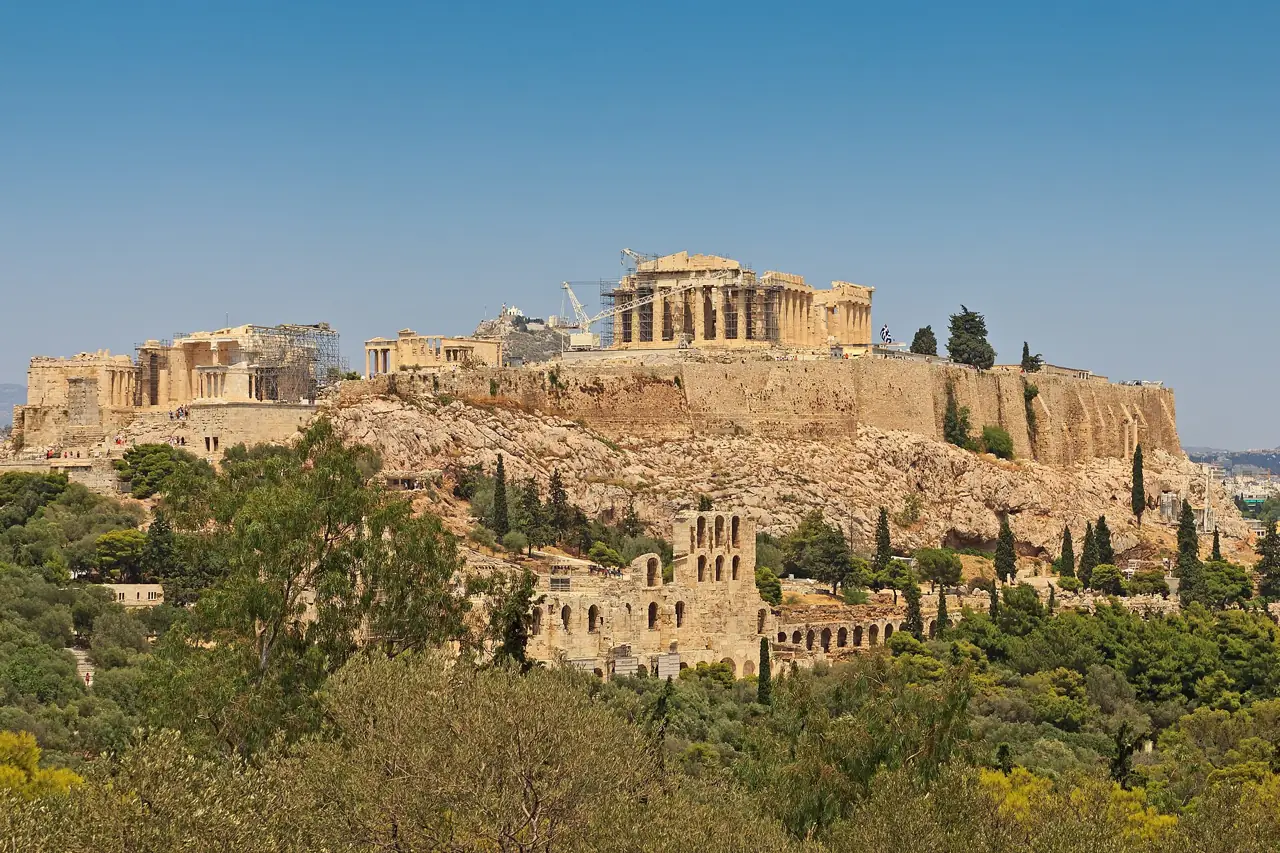 The Acropolis hill with the Parthenon on top, seen across olive trees from Philopappos Hill