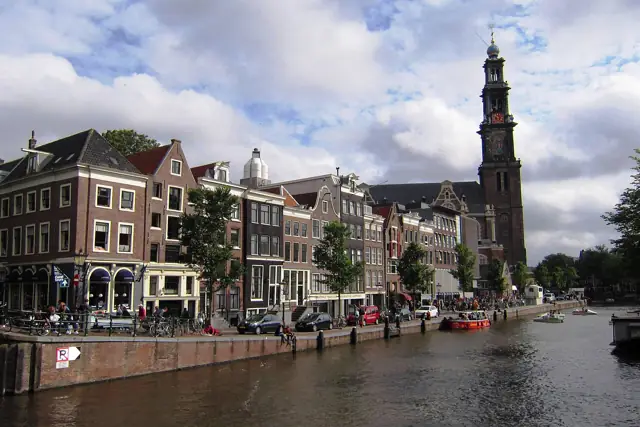 Canal houses along the Prinsengracht in Amsterdam with the tower of the Westerkerk