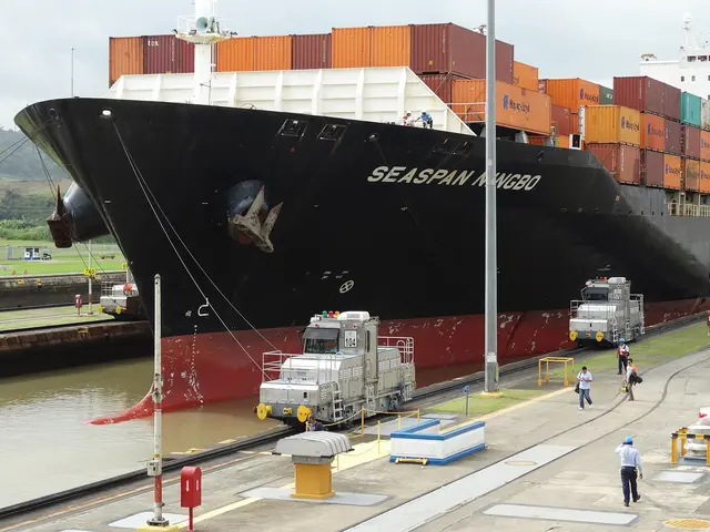 A container ship guided by electric locomotives through the Miraflores Locks on the Panama Canal