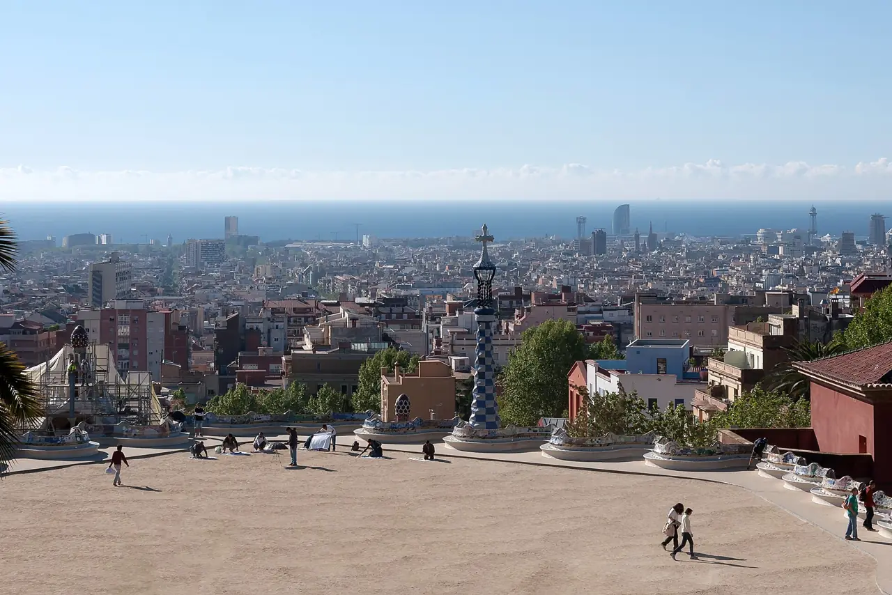 The main terrace of Park Güell with its mosaic benches, looking out over Barcelona towards the sea