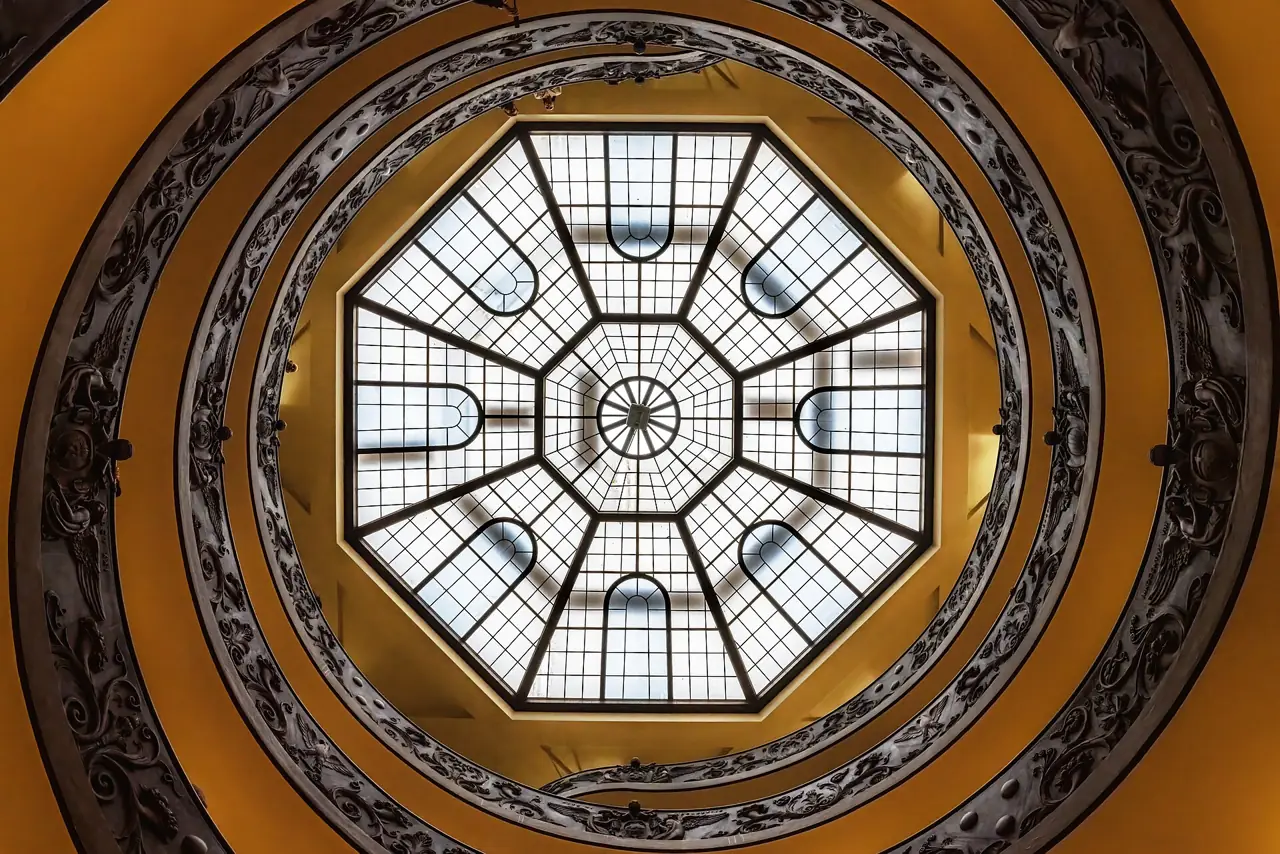 Looking up the spiral staircase of the Vatican Museums towards its glass skylight