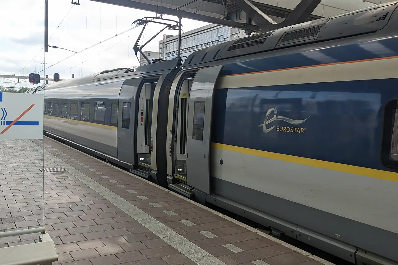 A Eurostar high-speed train waiting at a platform in Rotterdam Centraal station