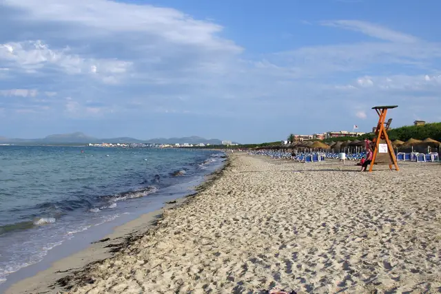 Wide, gently shelving sandy beach at Playa de Muro in northern Mallorca with calm shallow water