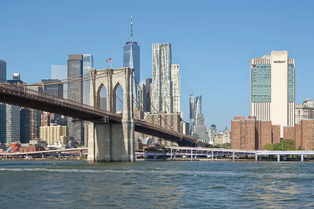 The Brooklyn Bridge and the skyscrapers of Lower Manhattan seen from a boat on the East River on a sunny day