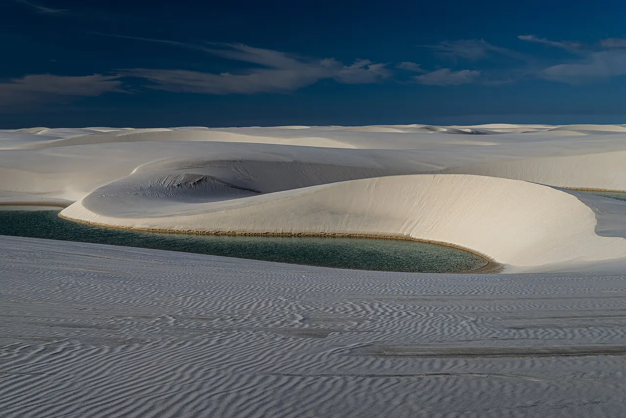 White sand dunes and a rainwater lagoon in Lençóis Maranhenses National Park in north-eastern Brazil