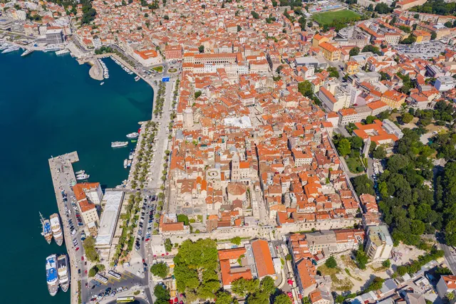 Aerial view of Split's old town and Diocletian's Palace with the palm-lined Riva promenade and harbour beside it