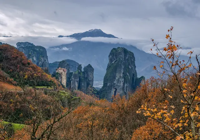 Rousanou Monastery on a rock pinnacle among the sandstone towers of Meteora with autumn trees in the foreground