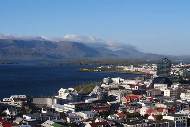 View over the colourful rooftops of Reykjavik towards the bay and Mount Esja from the Hallgrímskirkja tower