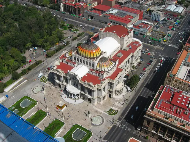 Aerial view of the Palacio de Bellas Artes with its orange and gold domes in central Mexico City