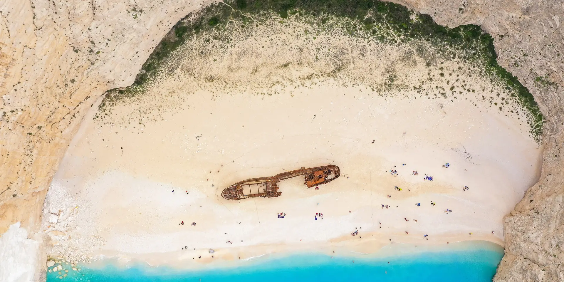 Aerial view of Navagio Beach on Zakynthos, Greece, with turquoise water, white cliffs and the shipwreck on the sand